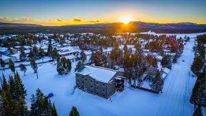 an aerial view of a resort in the snow at sunset at Wagon Wheel Hotel in West Yellowstone