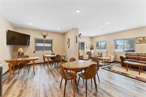 a living room with tables and chairs and a couch at Wagon Wheel Hotel in West Yellowstone