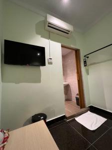 a room with a wall with a tv on the wall at I Go Inn in Bandar Saujana Putra