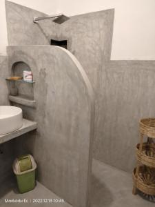 a bathroom with a sink and a concrete wall at Madoldu eco resort in Koggala