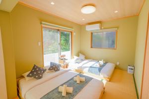 una stanza con due letti e una finestra di #3LDK一軒家 #長期滞在可能 #海まで4分-- Starry Sky Resort Okinawa -- a Onna