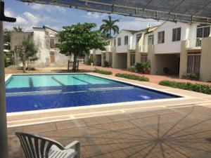 a swimming pool in front of a house at Conjunto Buganviles - Casa No 7 o 3 in Girardot