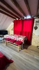 a bed in a room with a red curtain at Appartement Chalet Pra Loup in Uvernet-Fours