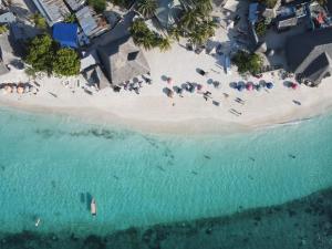 an aerial view of a beach with people and umbrellas at Siri Beach Lodge in Nungwi
