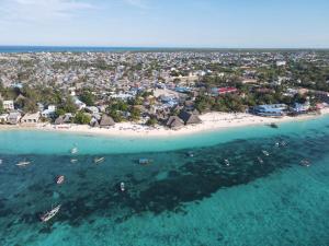 an aerial view of a beach with boats in the water at Siri Beach Lodge in Nungwi