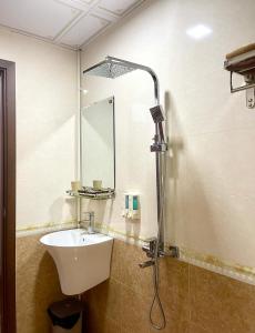 a bathroom with a sink and a shower at Tình Hiếu Hotel in Ha Long