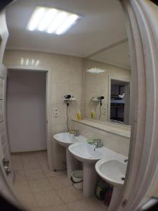 a bathroom with two sinks and a mirror at Солензара in Mukacheve