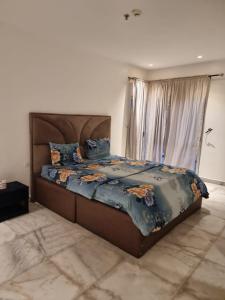 a bedroom with a large bed with a large window at Luxury 3 Bedroom with Pool and Gym In Oniru Victoria Island Lagos in Lagos