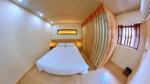Ліжко або ліжка в номері Tulou Fuyulou Changdi Inn