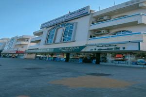 a large building with signs on the side of it at Khorfakkan Hotel Apartments in Khor Fakkan