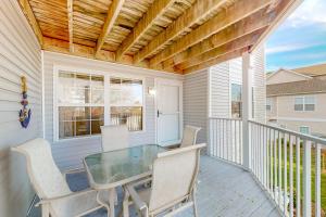 a patio with a table and chairs on a balcony at Bethany Bay --- 37514 Pettinaro Dr # 9404 in Ocean View