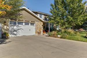 a house with a driveway and a white garage at Heart of Orem Basement 3 bedroom Apartment w/ Waffles. in Orem