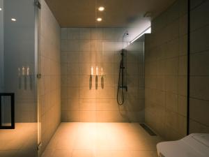 a bathroom with a shower with a toilet and a sink at MAOIQ in Naganuma +19 photos