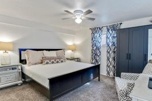 a bedroom with a bed and a couch at Heart of Orem Basement 3 bedroom Apartment w/ Waffles. in Orem