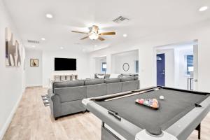 a living room with a pool table and a couch at Blue on Fox Run in Apollo Beach