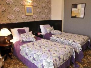 Postel nebo postele na pokoji v ubytování Riviera Hotel