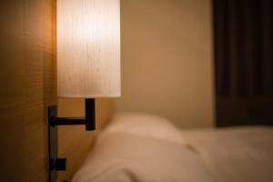 Postel nebo postele na pokoji v ubytování Tosei Hotel Cocone Ueno