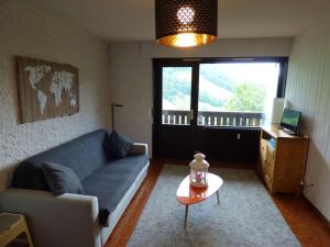 a living room with a couch and a table at Studio Le Grand-Bornand, 1 pièce, 4 personnes - FR-1-458-166 in Le Grand-Bornand