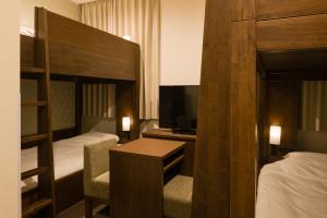 Postel nebo postele na pokoji v ubytování Tosei Hotel Cocone Ueno