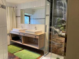 a bathroom with two sinks and a mirror at Spacious Holiday Home in Sankt Johann im Pongau with Garden in Sankt Johann im Pongau