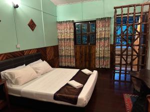 Кровать или кровати в номере Sepilok Jungle Resort