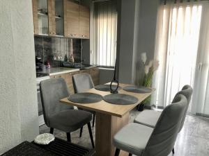 a kitchen with a wooden table with chairs and a kitchenventory at Centre apartment in Prilep