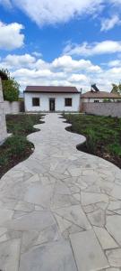 a stone walkway in front of a white building at Дом с красивым видом in Arzni