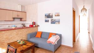 a living room with a blue couch and a table at Casas María Carmona - Casa Luna Níjar by Ruralidays in Níjar