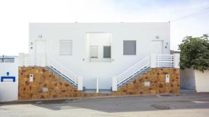 a white building with stairs on the side of it at Casas María Carmona - Casa Luna Níjar by Ruralidays in Níjar +9 photos