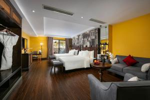 a hotel room with a bed and a couch at Hanoi Lion Boutique Hotel & Spa in Hanoi
