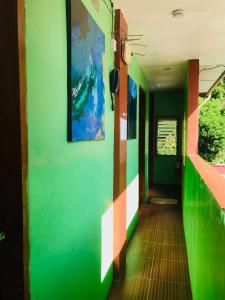 a hallway of a train with colorful walls at Queen's Room Rental 4 in El Nido