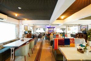 a restaurant with couches and tables and chairs at Bloom Boutique l Bandra in Mumbai