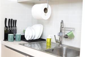 blat kuchenny ze zlewem i rolka papierowych ręczników w obiekcie ZAPBED House - Luxury Holiday Homes in Yas Island w Abu Zabi