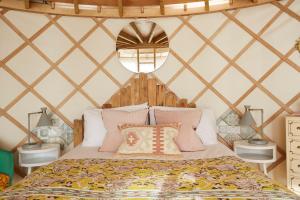 a bedroom with a bed in a yurt at Puckaster Cove Luxury Yurt in Niton