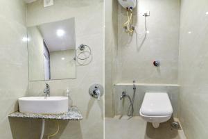 Vastral的住宿－FabExpress Canada，一间带水槽、卫生间和镜子的浴室