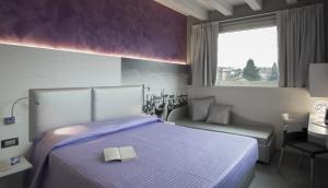 Postel nebo postele na pokoji v ubytování Hotel Doge