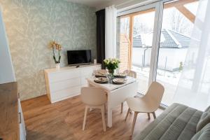 Televízia a/alebo spoločenská miestnosť v ubytovaní Świerkowy 3 Dolina Szczęścia Apart Invest