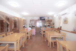 Alvilla Omi Maiko - Vacation STAY 14692v في أوتسو: غرفة طعام مع طاولات وكراسي خشبية