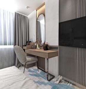 a bedroom with a desk with a television and a chair at Crowne Plaza Sofia, an IHG Hotel in Sofia