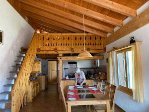 a woman standing in a kitchen with a table in a house at Casauma Gartmann in Vattiz