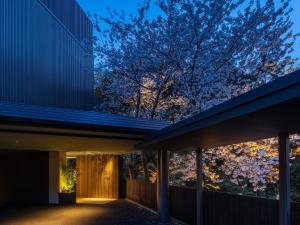 a house with a blue roof and a tree at Fufu Atami in Atami