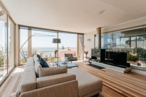 a living room with a couch and a tv at Bishops View, Villa in Cape Town