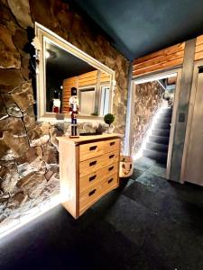 a stone bathroom with a sink and a mirror at Chalet Donky in Donovaly