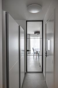 an open door leading to a dining room with a table at Casselbergh Residences Petunia - De Haan in De Haan