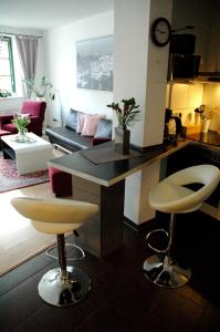 - une cuisine et un salon avec un comptoir et des tabourets dans l'établissement Sundappartement, à Stralsund