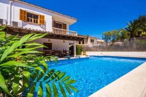 a swimming pool in front of a house at Ideal Property Mallorca - Eden Lago in Alcudia