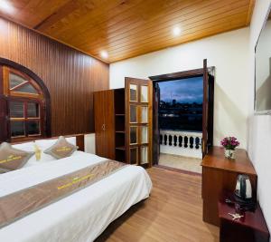 Un dormitorio con una cama grande y una ventana en Dalat Eco House, en Trai Mat