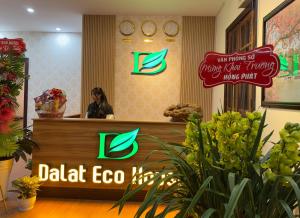 a woman sitting at a desk in a salon at Dalat Eco House in Trai Mat