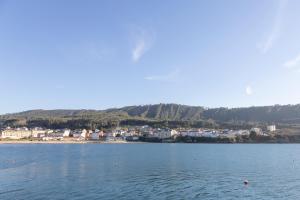 a large body of water with a town in the background at Apartagal-Mar de Vicedo in O Vicedo
