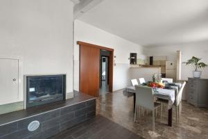 a living room with a dining table and a fireplace at Appartamento Greco by BarbarHouse in Borgagne +14 photos